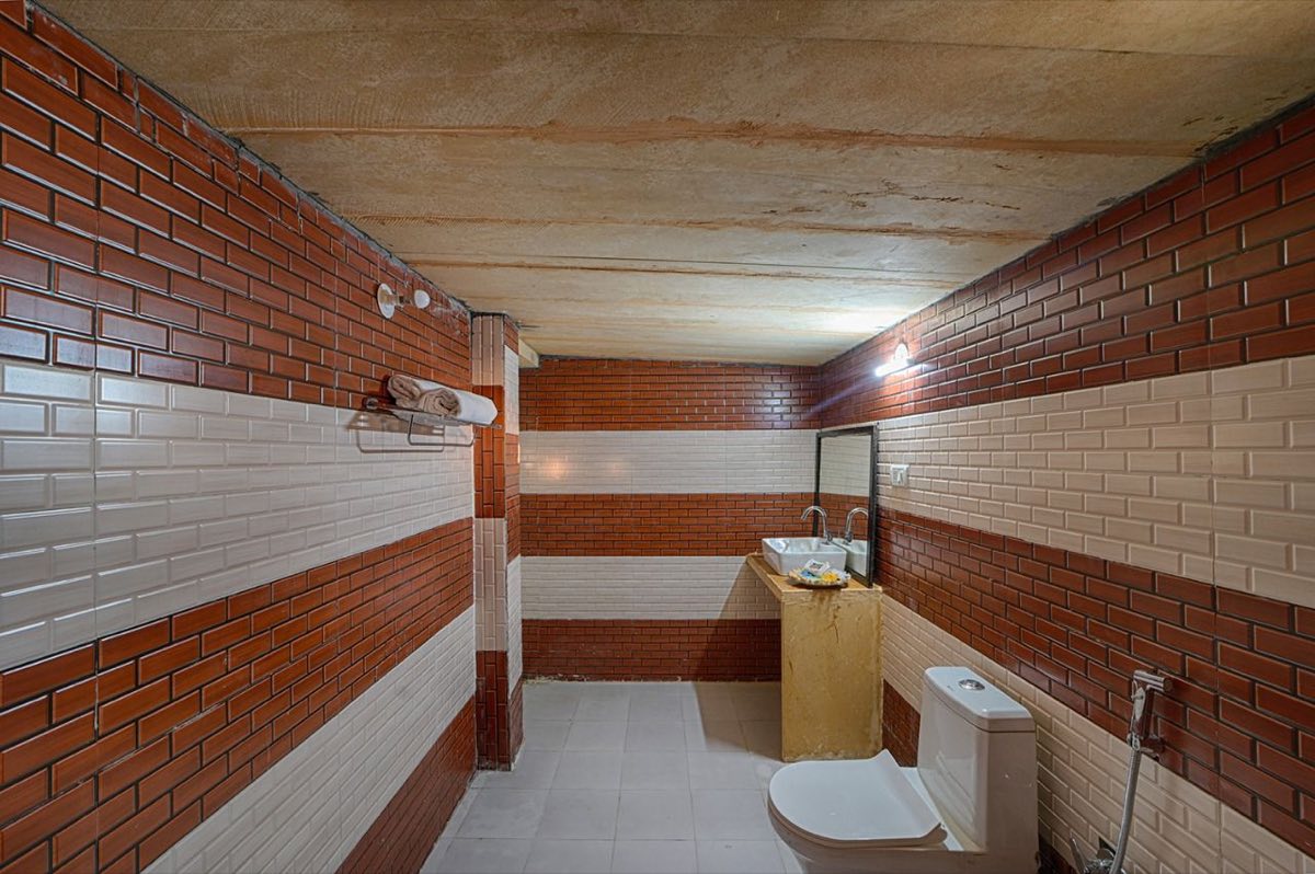 Attached bathroom with tiled walls inside a desert tent