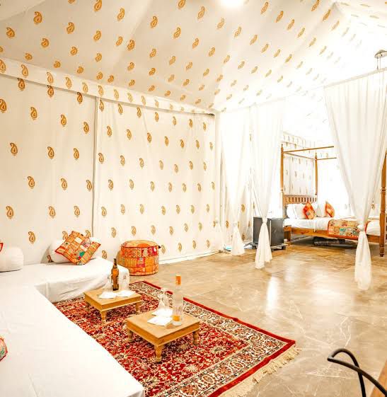 Bright Swiss tent lounge and bed area