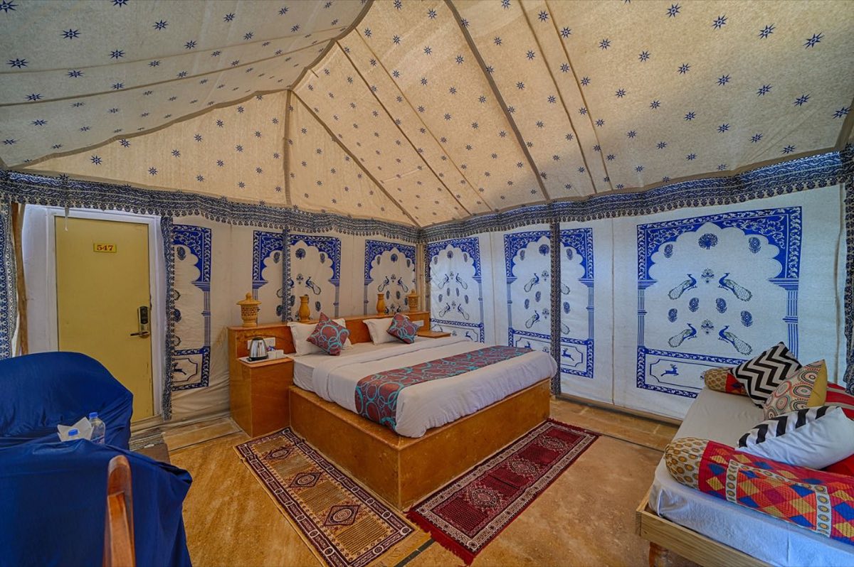 Family Swiss tent interior with double bed and lounge seating