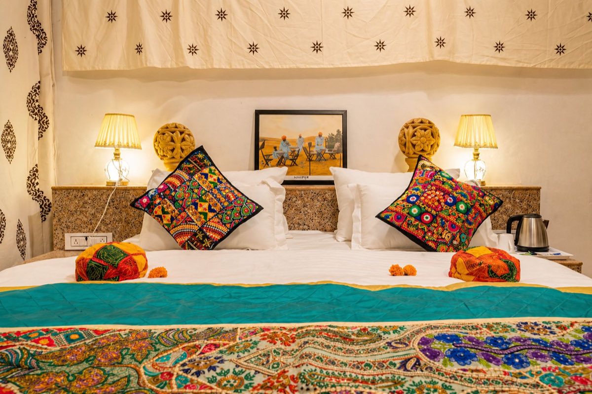 Rajasthani bed decor with colorful cushions in a Swiss tent
