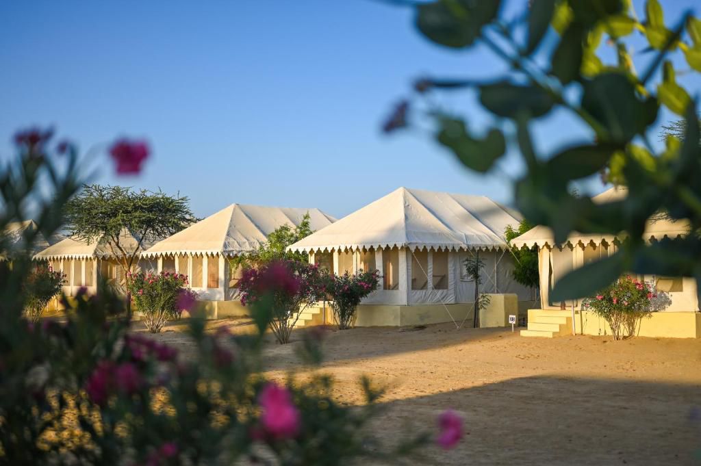 Swiss tents at Lucky Udan Resort with garden plants